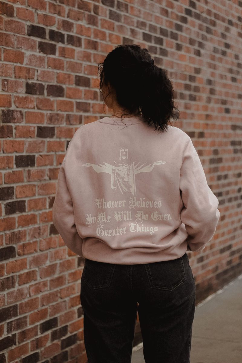 woman wearing pink greater things sweatshirt back